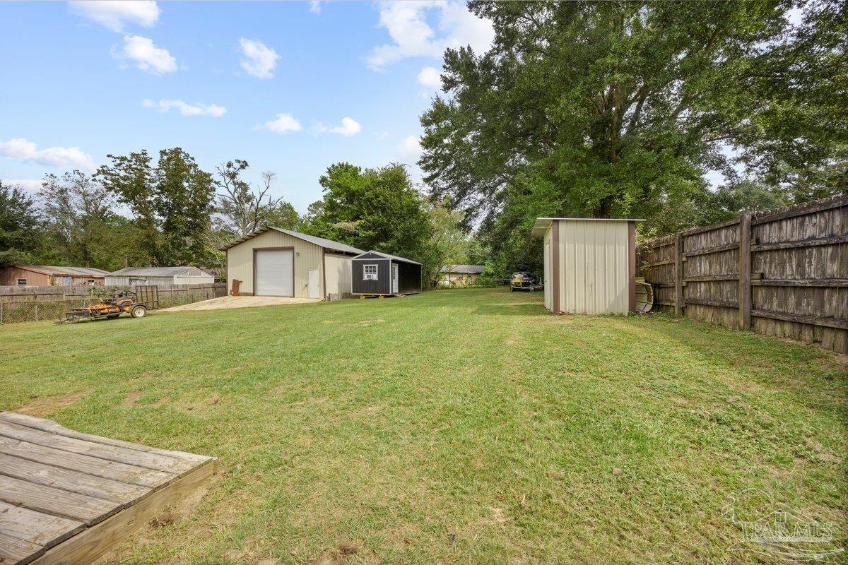 2194 Pompano Street Cantonment, FL 32533 - Photo 17 of 23 a front view of a house with garden