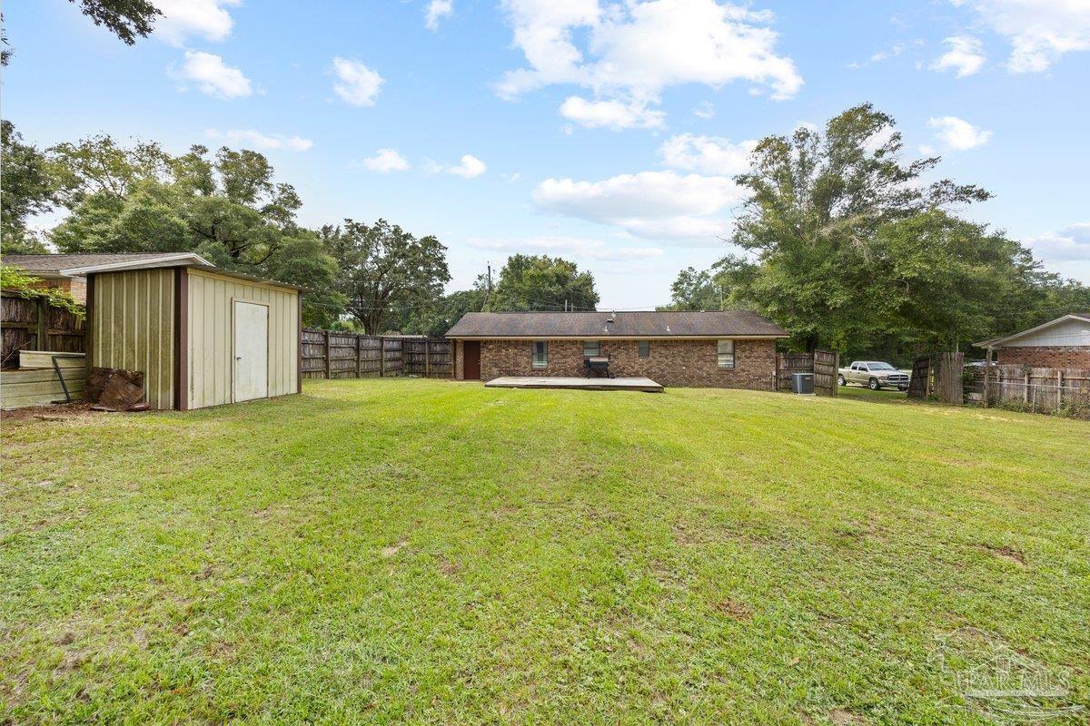 2194 Pompano Street Cantonment, FL 32533 - Photo 18 of 23 a view of a house with a yard