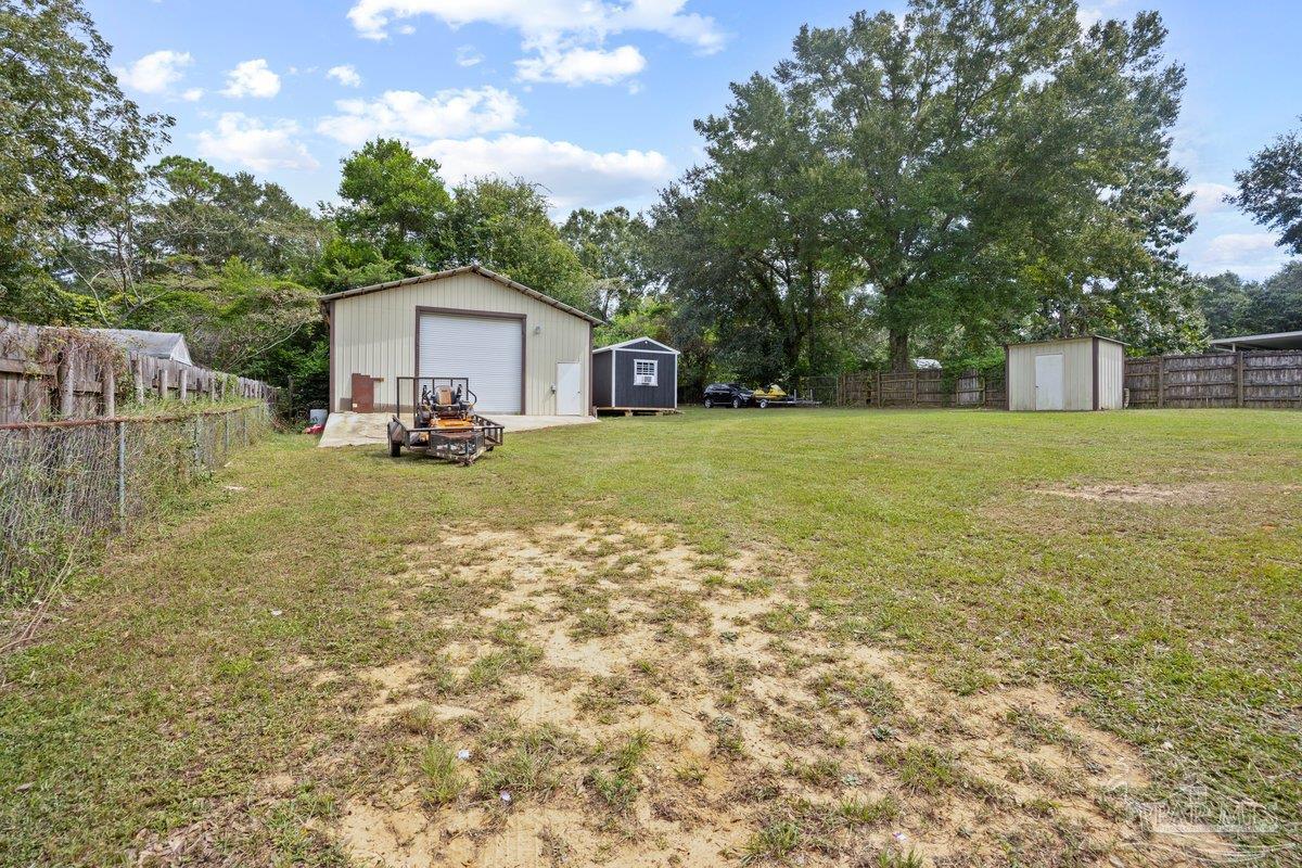 2194 Pompano Street Cantonment, FL 32533 - Photo 19 of 23 a view of a house with big yard and large trees