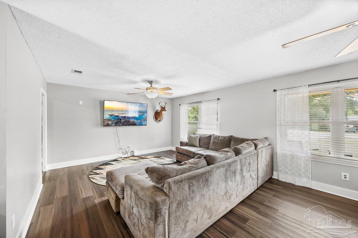 2194 Pompano Street Cantonment, FL 32533 - Photo 2 of 23 a living room with furniture and a wooden floor