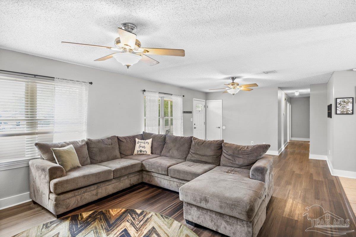 2194 Pompano Street Cantonment, FL 32533 - Photo 5 of 23 a living room with furniture and a large window