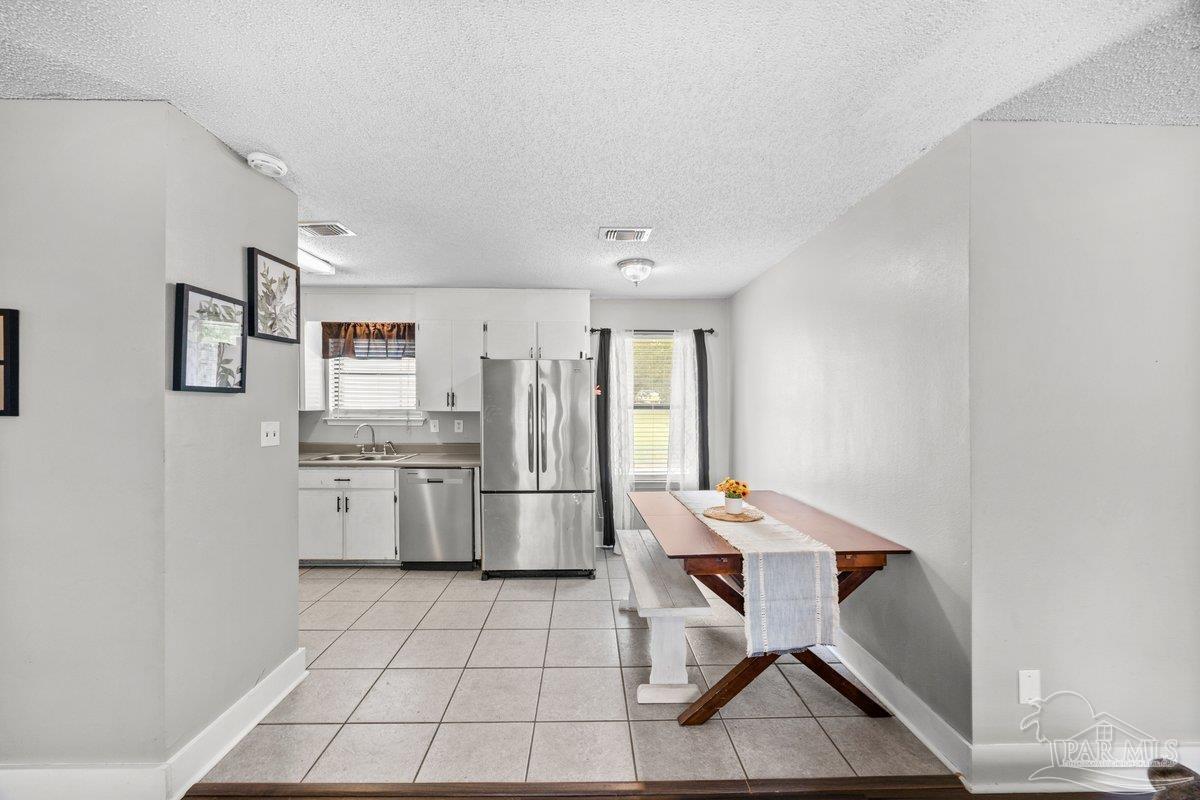 2194 Pompano Street Cantonment, FL 32533 - Photo 8 of 23 a kitchen with a cabinets and chairs