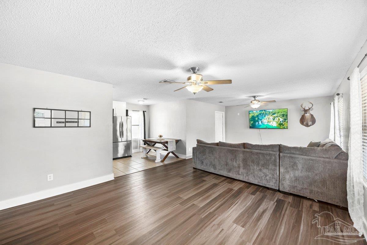 2194 Pompano Street Cantonment, FL 32533 - Photo 9 of 23 a living room with furniture and a wooden floor