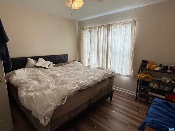 a bed sitting in a bedroom next to a window