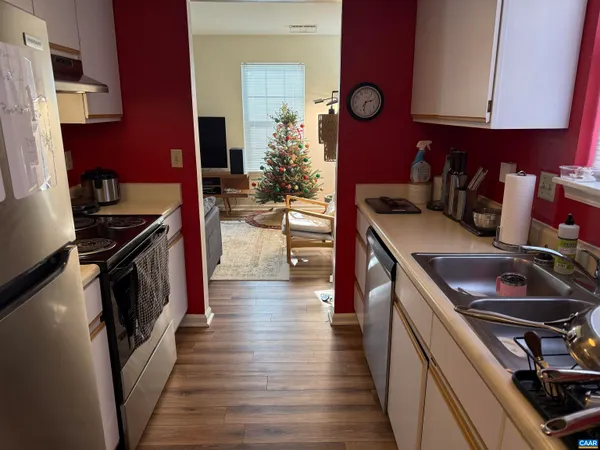 a kitchen with a stove and a wooden floors