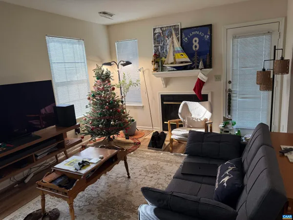 a living room with furniture a flat screen tv and a fireplace