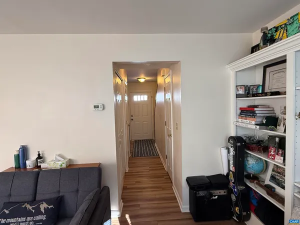 a view of a hallway with workspace and cabinets