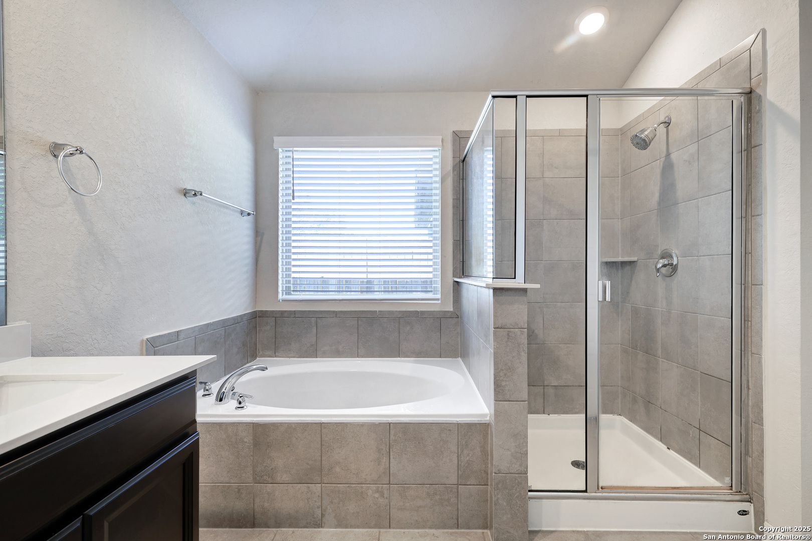 3168 Junction Bay Converse, TX 78109 - Photo 13 of 26 a bathroom with a bathtub and a shower