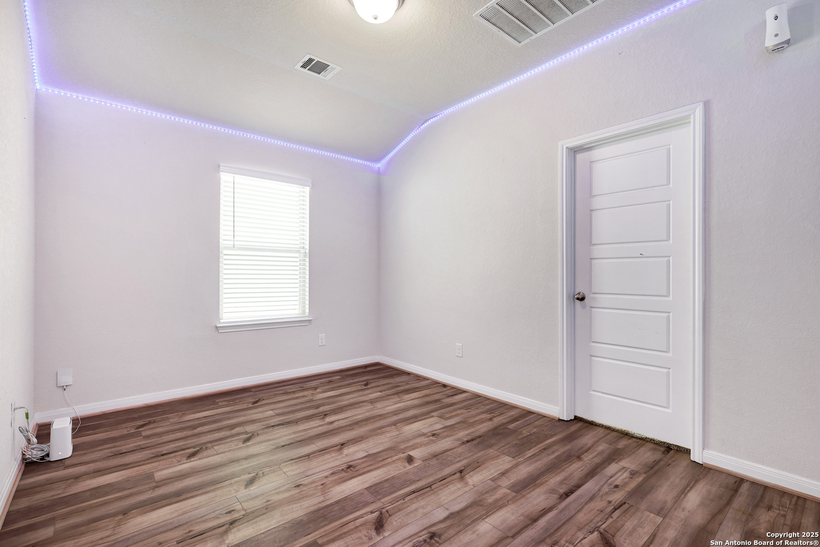 3168 Junction Bay Converse, TX 78109 - Photo 19 of 26 an empty room with wooden floor closet and windows