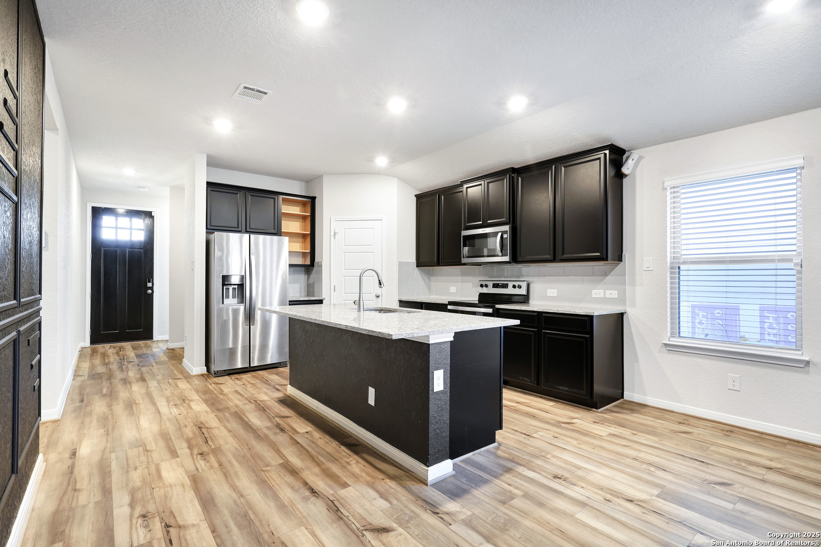 3168 Junction Bay Converse, TX 78109 - Photo 4 of 26 a large kitchen with stainless steel appliances granite countertop a large counter top a stove a refrigerator and a sink