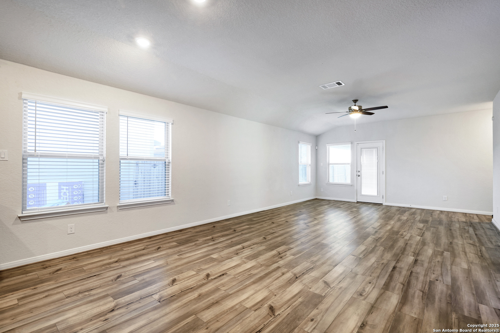 3168 Junction Bay Converse, TX 78109 - Photo 6 of 26 wooden floor in an empty room with a window
