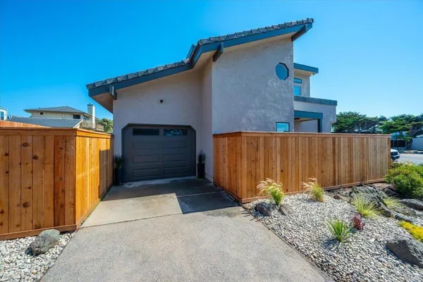 a view of a house with a wooden fence
