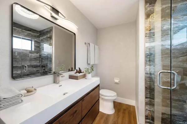 a bathroom with a sink toilet and shower