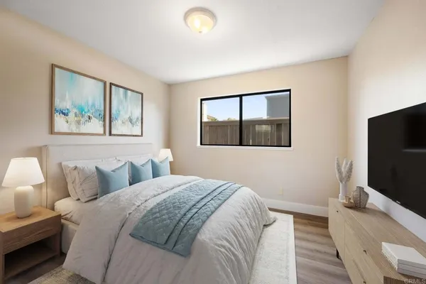 a bedroom with a bed and a flat screen tv
