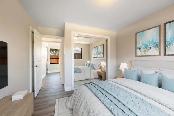 a bedroom with bed and wooden floor