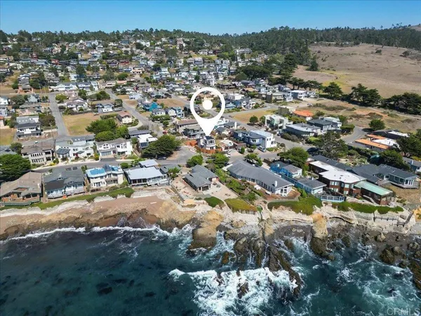 an aerial view of multiple houses with yard
