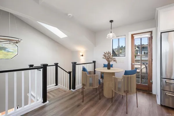 a view of a dining room with furniture window and wooden floor