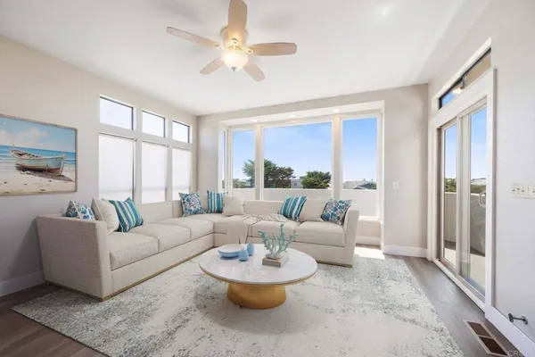 a living room with furniture and a large window