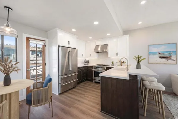 a kitchen with a sink stainless steel appliances and cabinets