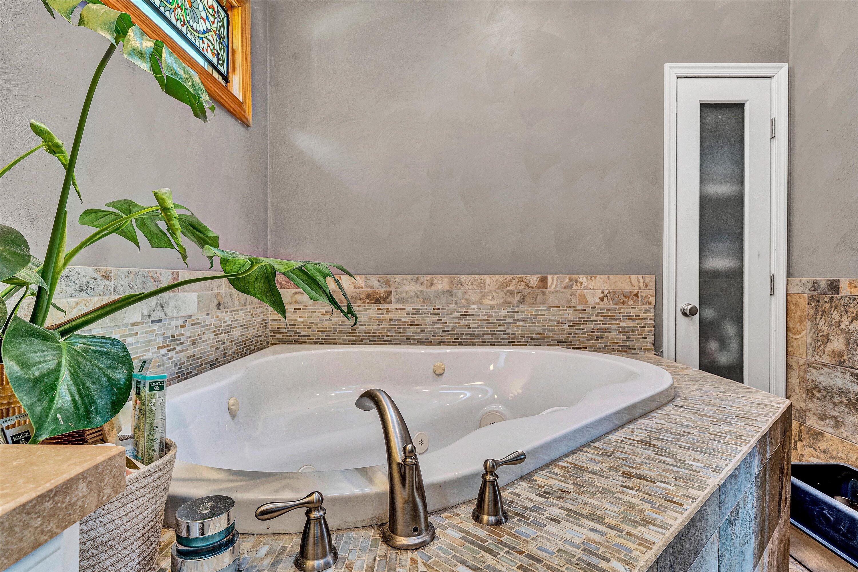 1013 Howbert Avenue Southwest Roanoke, VA 24015 - Photo 35 of 52 a bath tub sitting in a bedroom next to a potted plant