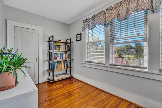 a living room with furniture and a book shelf