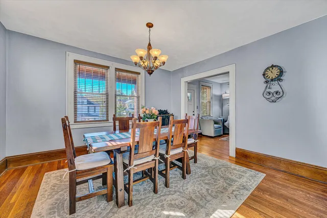a view of a dining room with furniture wooden floor and chandelier