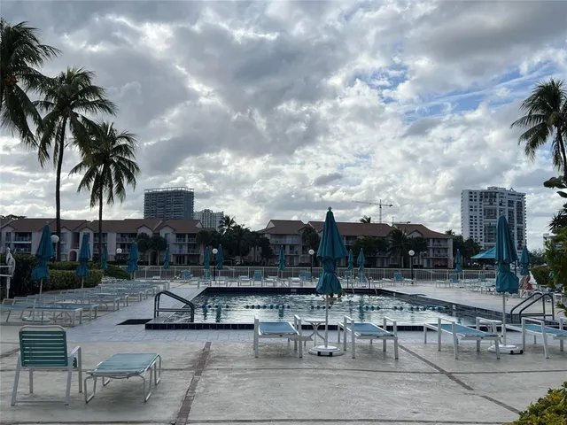 a view of a patio with swimming pool table and chairs