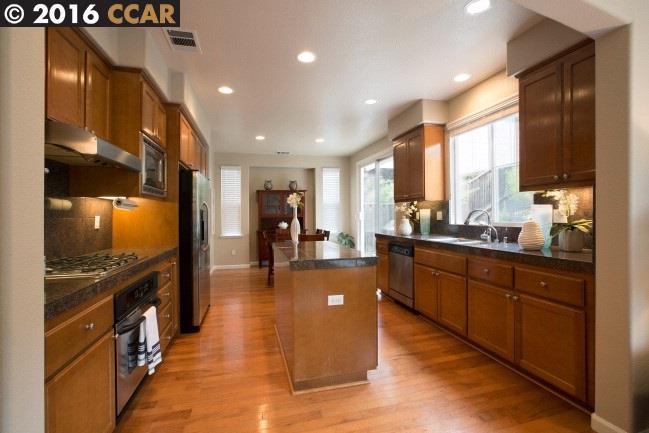 2153 North Donovan Way San Ramon, CA 94582 - Photo 5 of 15 a large kitchen with stainless steel appliances granite countertop a large counter top a stove and a refrigerator