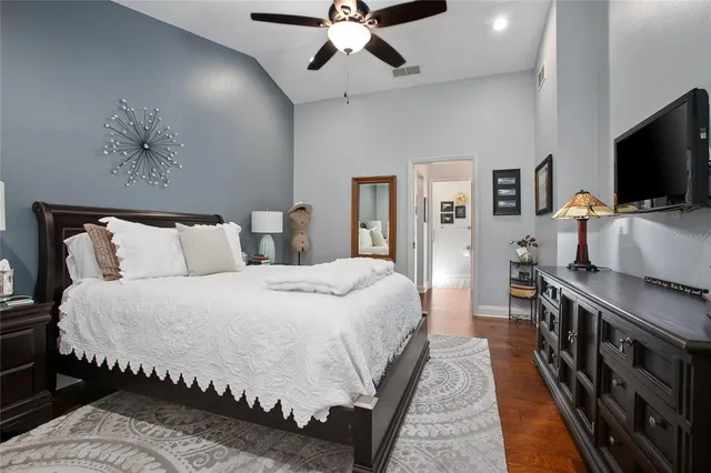 a bedroom with a bed and a flat screen tv