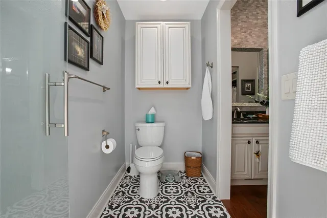 a hallway view with fireplace and cabinets
