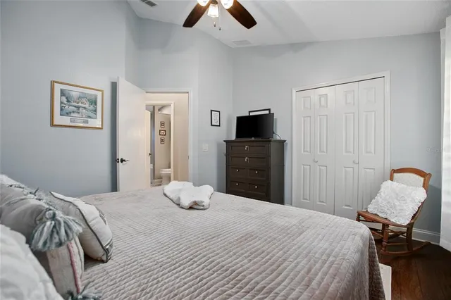 a bathroom with a granite countertop toilet sink and mirror