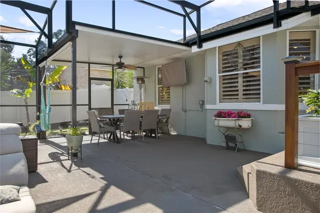 a outdoor space with the couches and a potted plant on the table