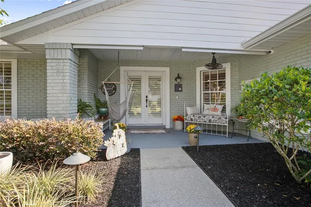a front view of a house with outdoor seating