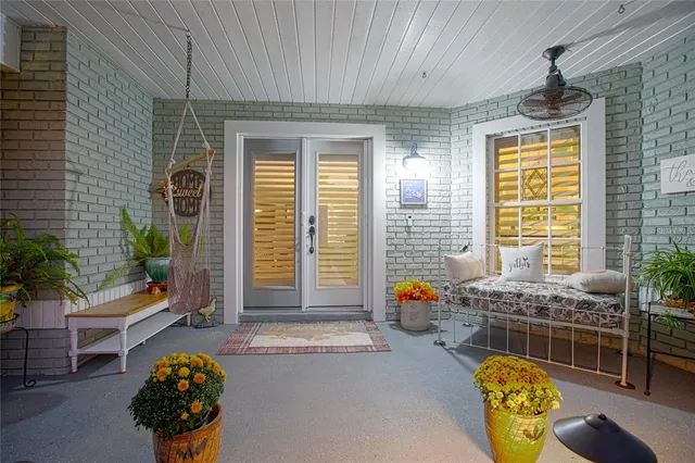 a view of a house with backyard and sitting area