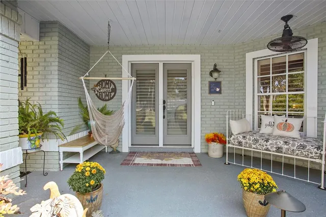 a living room with furniture kitchen view and a wooden floor