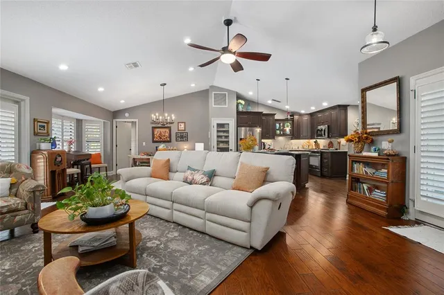 a dining table with stainless steel appliances kitchen island granite countertop a dining table chairs and a refrigerator