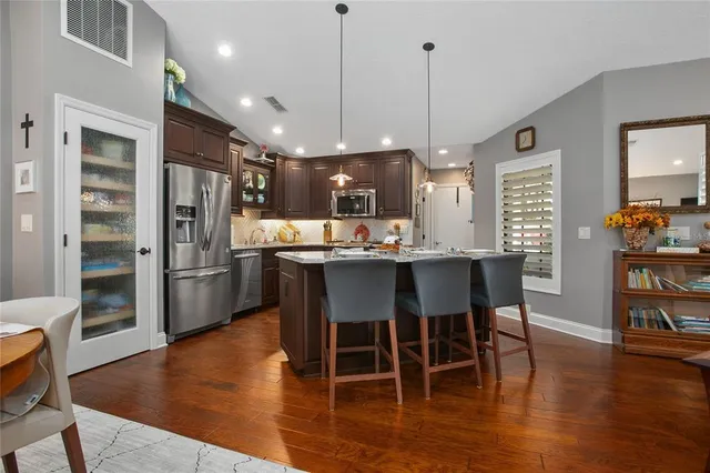 a kitchen with granite countertop stainless steel appliances and wooden cabinets