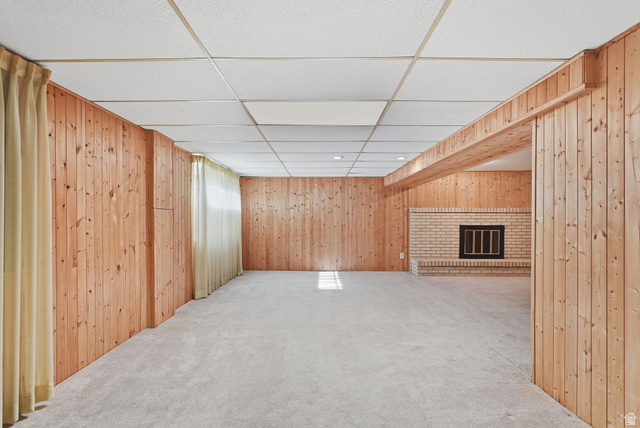 2524 Camelback Road Cottonwood Heights, UT 84121 - Photo 31 of 49 Recessed lighting, drop ceiling, wood-paneled walls, brick fireplace with black grate, and light-toned carpeting