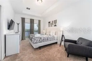 a bedroom with a bed couch and a window