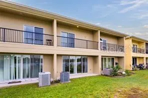 front view of a brick building with a yard