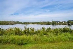 a view of a lake with houses in the back