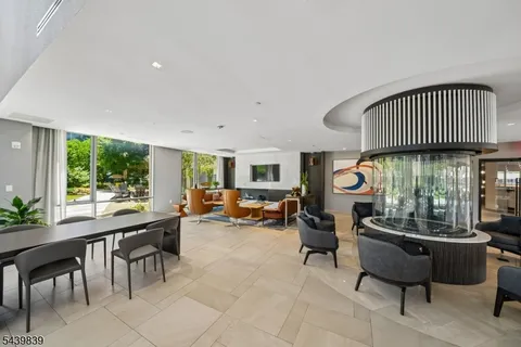 a room with lots of furniture and a potted plant