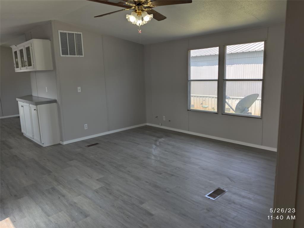 307 Jones Circle Pottsboro, TX 75076 - Photo 2 of 11 wooden floor in an empty room with a window