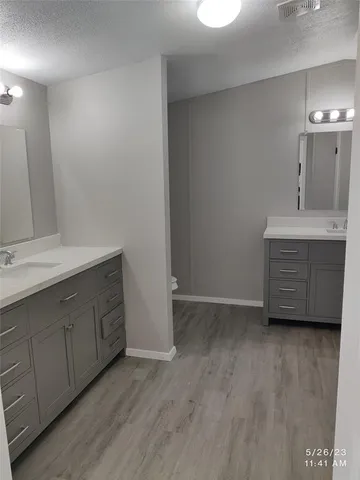 a view with cabinets and wooden floor