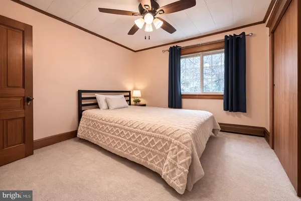 a bedroom with a bed and window