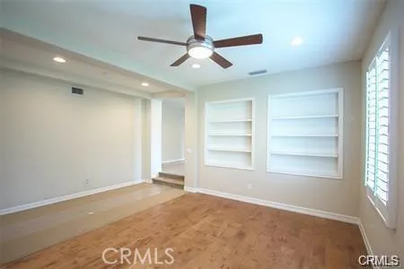 an empty room with windows and closet