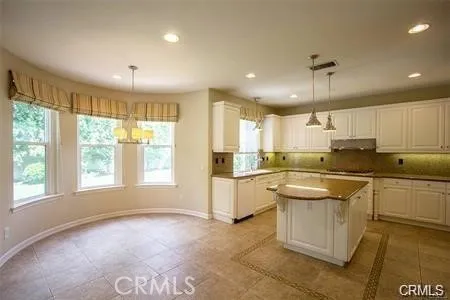 a kitchen with a sink window and cabinets