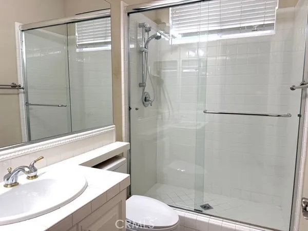 a bathroom with a shower and a sink