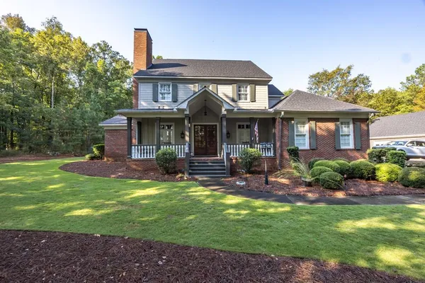 a view of a house with a yard porch and sitting area