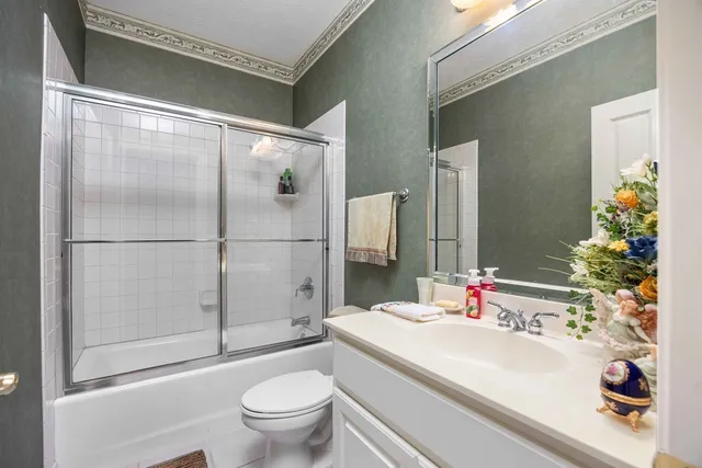 a bedroom with a bed gym equipment and view of living room